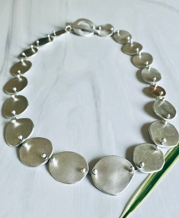 NCK Irregular shaped fine silver pebbles, heat rivet links, sterling silver toggle clasp by Lisa Gent